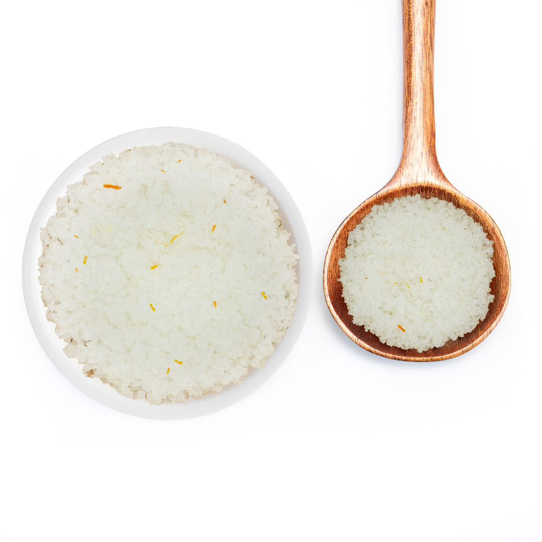 Saffron Fleur De Sel Sea Salt in a white bowl on a wood spoon
