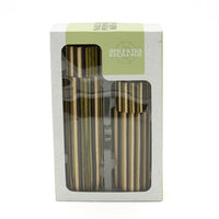 A boxed set of two striped mills with matching lids, presented in a white retail package with a clear window and a pale green label. The package shows the visible brand name 'Spice & Tea Exchange'.