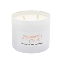 White candle with 'Strawberry Clouds' text on a white background