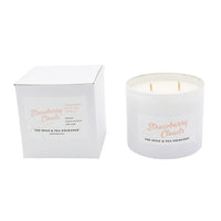 White candle with 'Strawberry Clouds' branding next to its white box on a white background