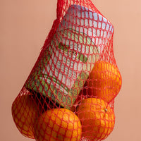 Tangerine green tea in paper tube in tea field design in red mesh product bag with tangerines