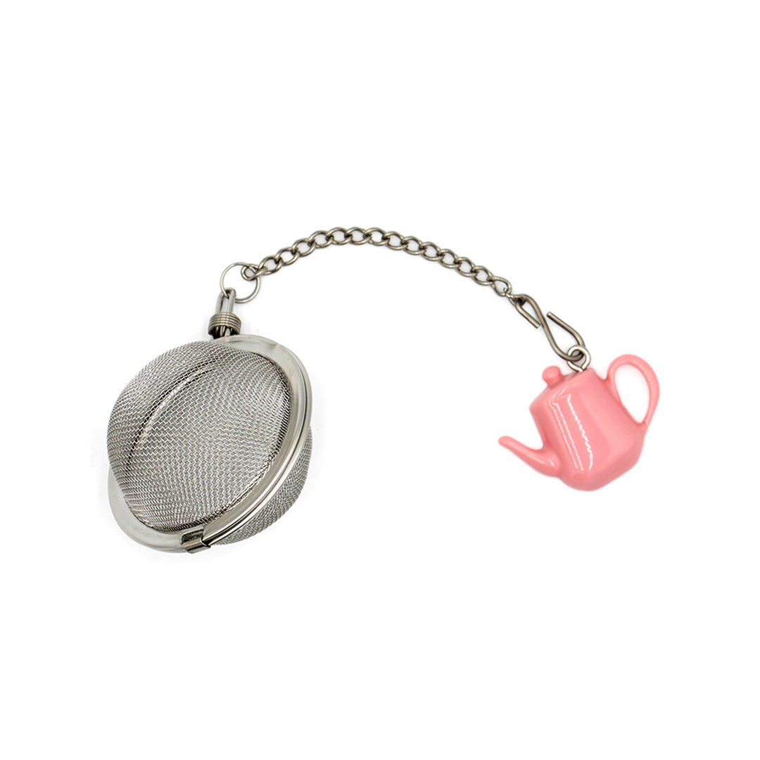 Tea ball with a pink teapot charm on a white background