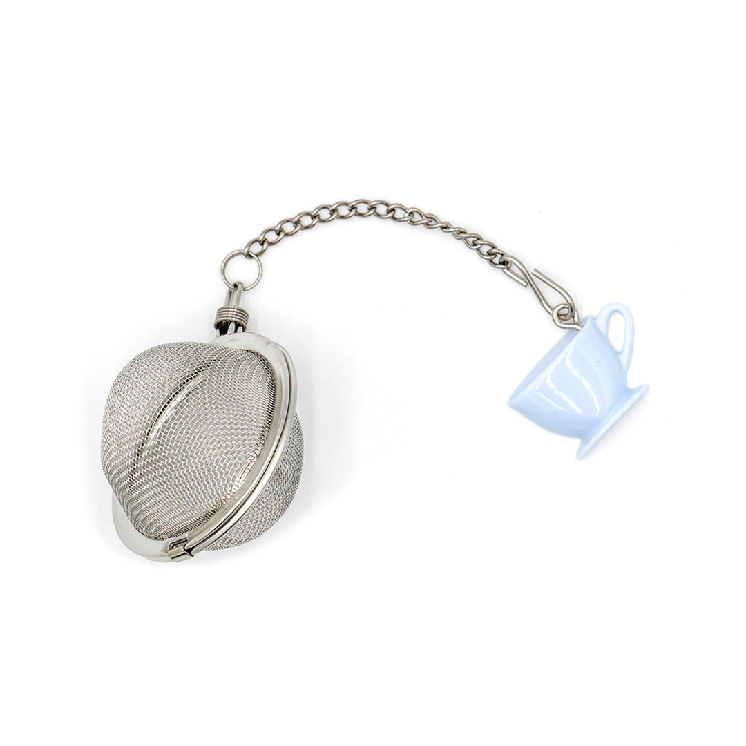 Metallic tea ball with a chain and a small cup-shaped ornament on a white background