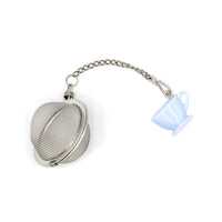 Metallic tea ball with a chain and a small cup-shaped ornament on a white background