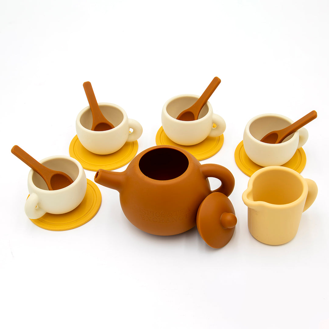 The Tiny Tea Party Toy Set includes a brown teapot with lid, four cream cups with saucers and spoons, and a small creamer—ideal for play kitchen fun and endless pretend tea parties on a white background.