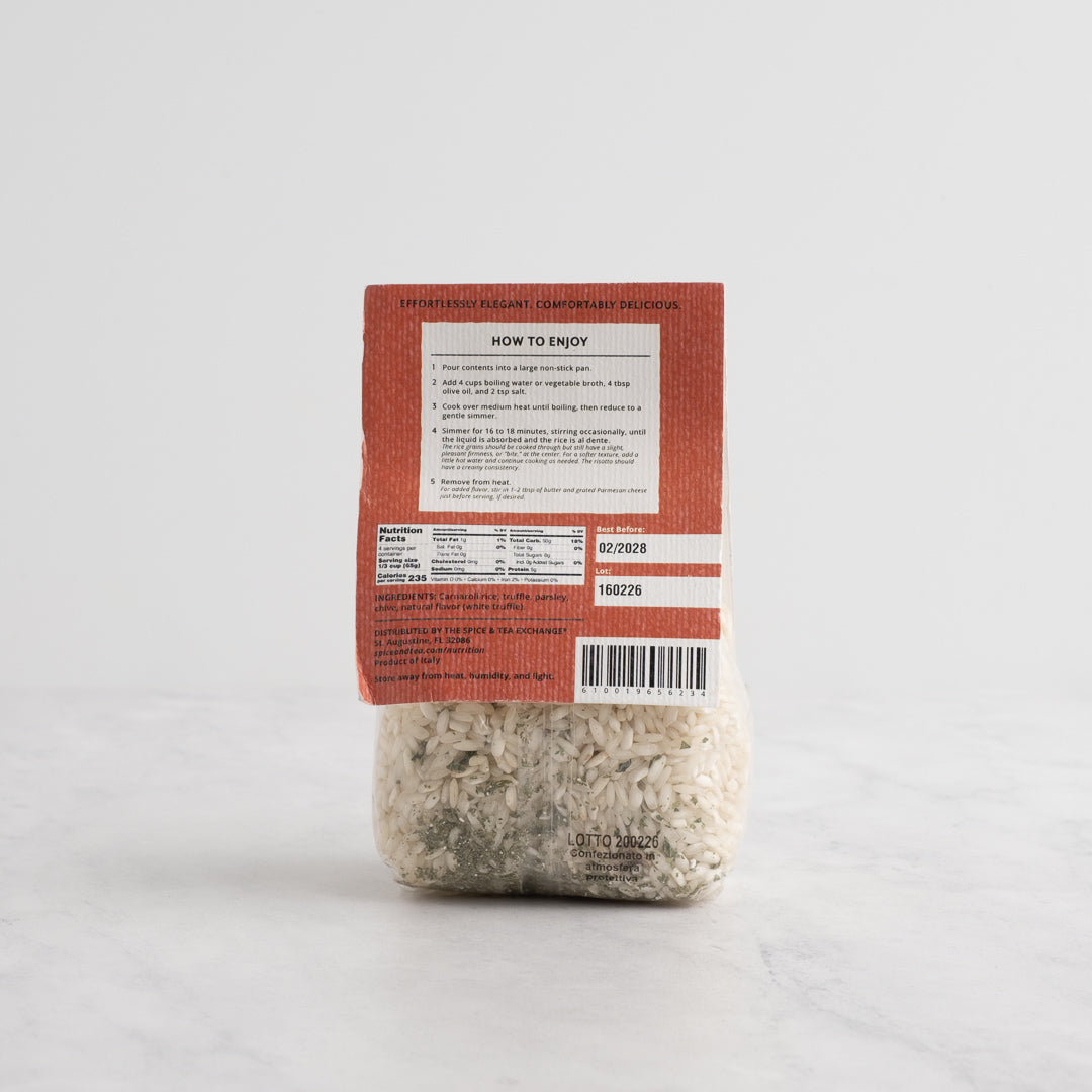 A package of Truffle Risotto rice from The Spice & Tea Exchange, featuring a white paper label with elegant gray patterns and a clear lower section showing the risotto grains inside, set against a clean white background. Back side.