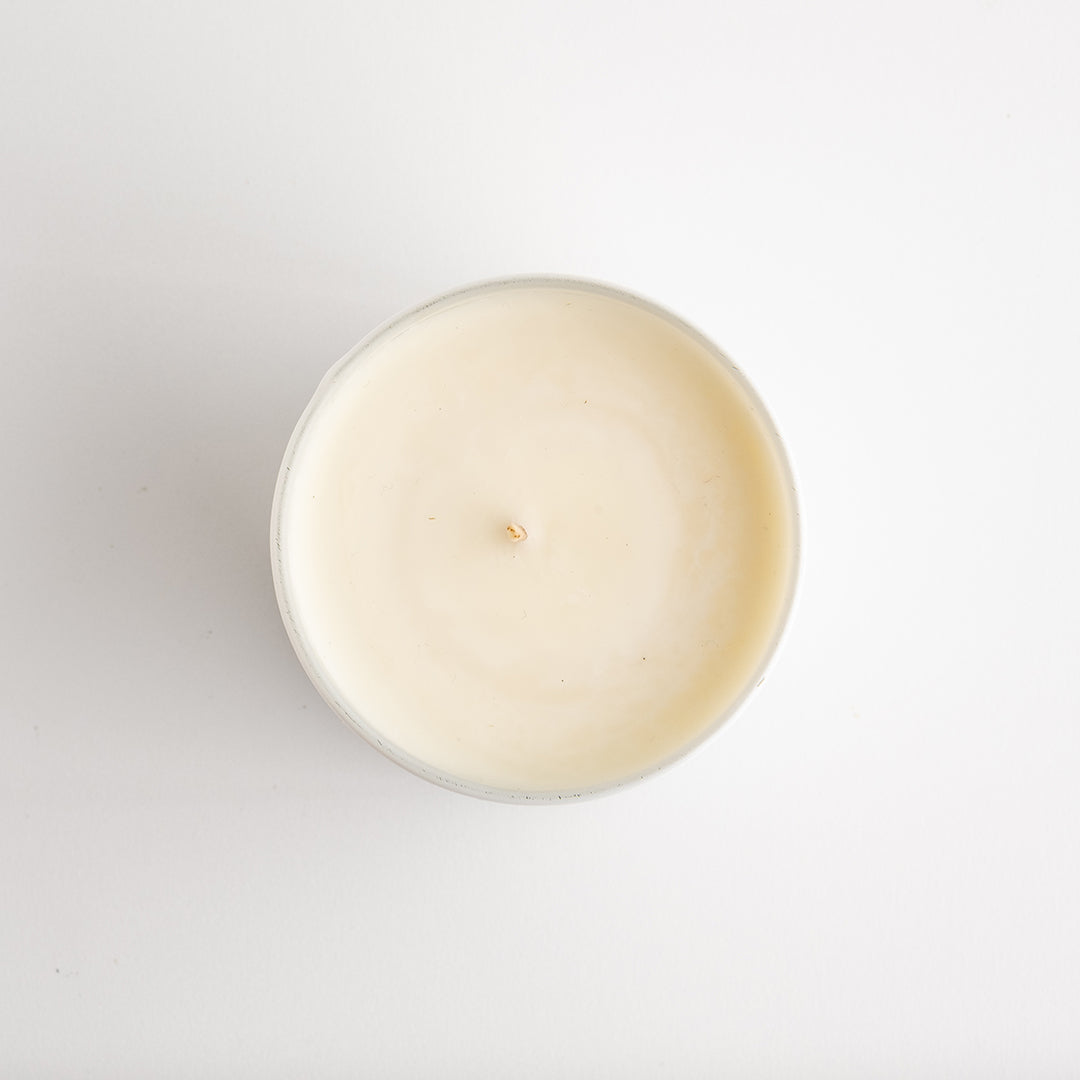 A white glass candle jar from top.