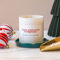 White chocolate peppermint candle with decorative elements on a table
