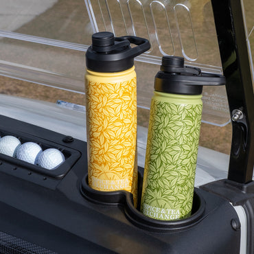 Two patterned water bottles in a golf cart cup holder with golf balls in the background.
