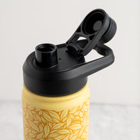 Yellow water bottle with black lid and handle on a light gray background
