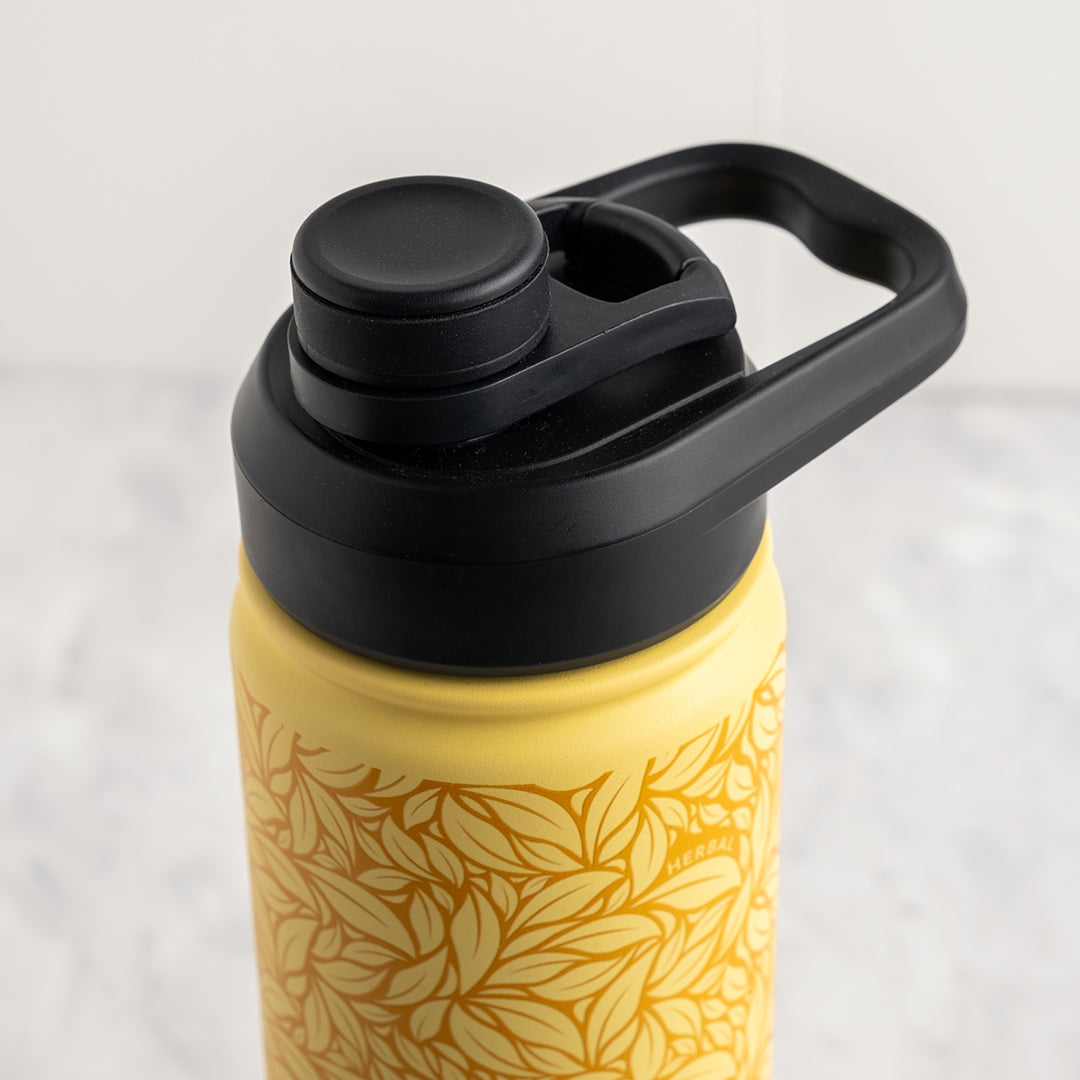 Yellow water bottle with black lid and handle on a light gray background